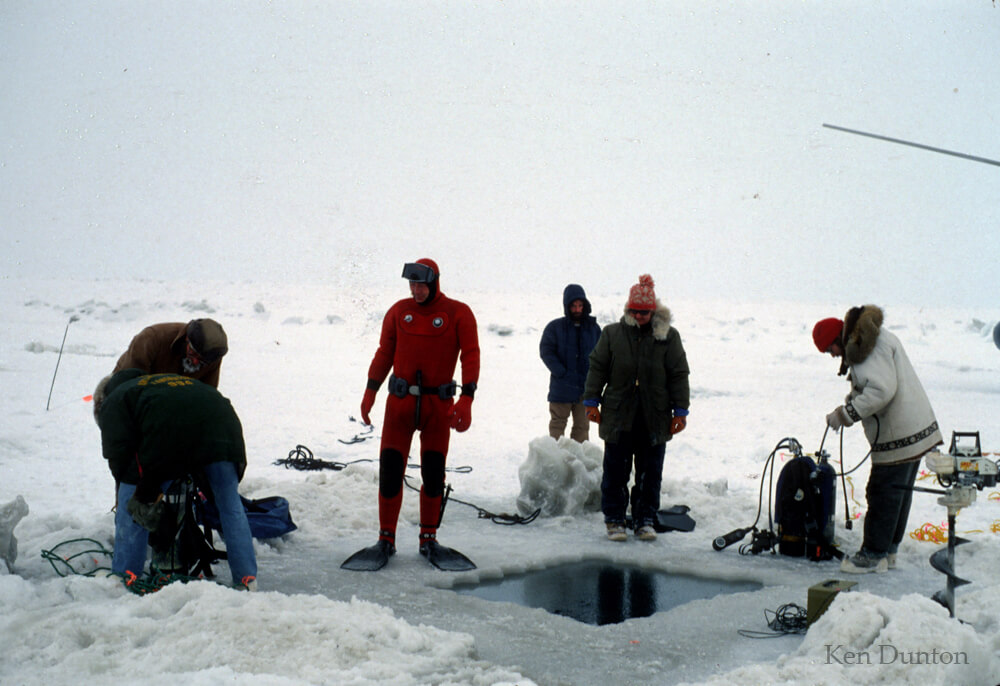 Geologist Erk Reimnitz, center, who initially dicovered the Boulder Patch, preparing for a dive in spring 1979